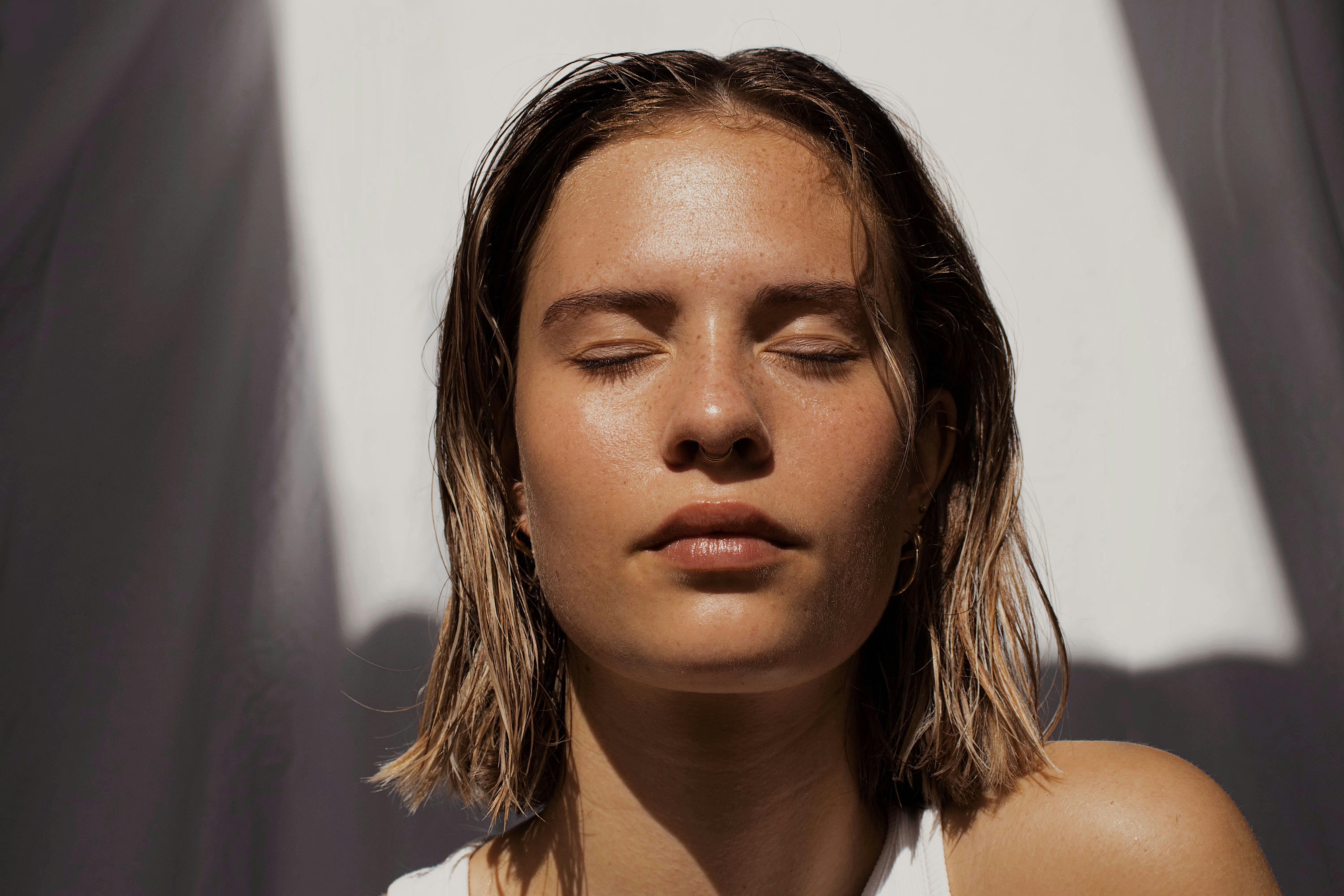 Woman with damp hair in soft sunlight