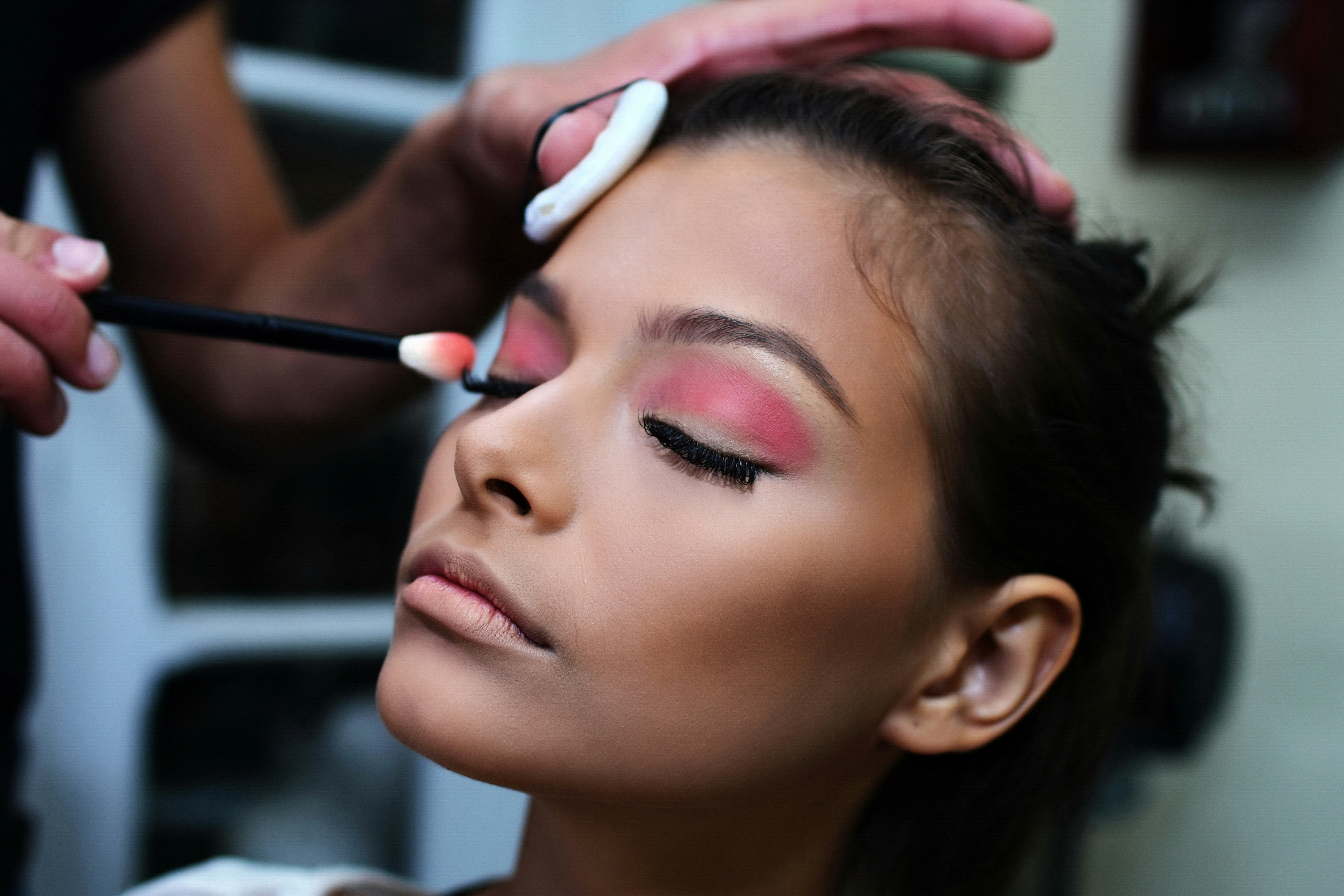 Makeup artist applying eyeshadow close-up
